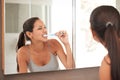 No bad breath for me. A beautiful young woman brushing her teeth in her bathroom. Royalty Free Stock Photo