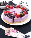 No-bake blueberry cheesecake on the dark kitchen cloth and white table surrounded by berries