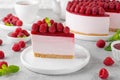 No baked raspberry cheesecake or raspberry cream mousse cake with jelly and fresh berries on top on a white plate Royalty Free Stock Photo