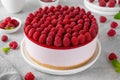 No baked raspberry cheesecake or raspberry cream mousse cake with jelly and fresh berries on top on a white plate Royalty Free Stock Photo