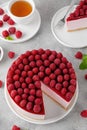 No baked raspberry cheesecake or raspberry cream mousse cake with jelly and fresh berries on top on a white plate Royalty Free Stock Photo