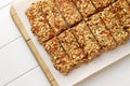 No baking granola bars on white wooden table.