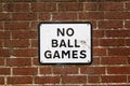 A No ball games sign on a brick wall on the side of a property Royalty Free Stock Photo