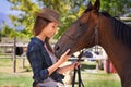 No bond stronger than a rider and steed. a young cowgirl standing outside with her horse. Royalty Free Stock Photo