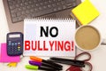 No Bullying text in the office with surroundings such as laptop, marker, pen, stationery, coffee. Business concept for Bullies Pre