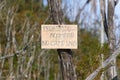 No camping sign on a tree in Spanish and English Royalty Free Stock Photo