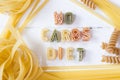No carbs diet text written with colorful pastas on white wooden background