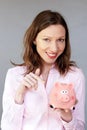 Money savings confident woman holding pink piggy bank moneybox Royalty Free Stock Photo