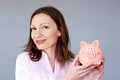 Money savings no stress woman holding moneybox piggy bank Royalty Free Stock Photo