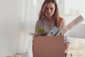 Sad downhearted woman holding a box with her office stuff Royalty Free Stock Photo