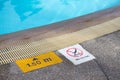 No diving and depth sign warning at swimming pool edge Royalty Free Stock Photo