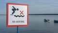 No Diving sign at beach, lake Naroch, Belarus. Warning sign of shallow water. Warning notice sign do not jump in water. Royalty Free Stock Photo