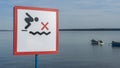 No Diving sign at beach, lake Naroch, Belarus. Warning sign of shallow water. Warning notice sign do not jump in water.