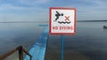 No Diving sign at beach, lake Naroch, Belarus. Warning sign of shallow water. Warning notice sign do not jump in water. Royalty Free Stock Photo