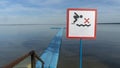 No Diving sign at beach, lake Naroch, Belarus. Warning sign of shallow water. Warning notice sign do not jump in water