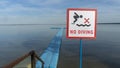 No Diving sign at beach, lake Naroch, Belarus. Warning sign of shallow water. Warning notice sign do not jump in water