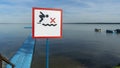 No Diving sign at beach, lake Naroch, Belarus. Warning sign of shallow water. Warning notice sign do not jump in water