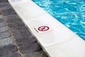 A no diving sign on the edge of a swimming pool