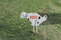 No dog toilet sign on a lawn. symbol of dog pooping prohibition