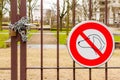 No dogs allowed sign and locked park gate with pad lock