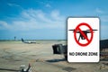 No drone flying warning sign witha generic airport blurred background