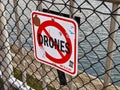 No Drones sign at the pier in downtown Seattle at the waterfront park, covered in stickers and graffiti