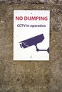 No dumping CCTV in operation sign on a wall. Anti littering campaign