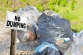 No Dumping concept with illegal garbage abandoned in nature