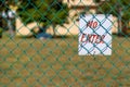 No Enter sign on green fence close up outdoors