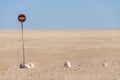 No entry or passage prohibited sign in the middle of the Namib Desert isolated in front of blue sky