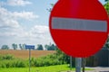 No entry road sign with left turn arrow and field behind Royalty Free Stock Photo
