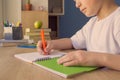 No face shot of a child boy writing in his copybook, doing homework at home Royalty Free Stock Photo