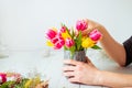 No face young man making spring bouquet using tulips. Online self-education of floristry. Learning flower arranging Royalty Free Stock Photo