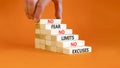 No fear limits excuses symbol. Concept words No fear no limits no excuses on wooden blocks. Beautiful orange background.