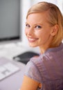 No first day jitters here. Portrait of a beautiful young woman sitting at her desk in an office.