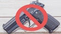 A no handguns sign of a black pistol with a red line through it Royalty Free Stock Photo