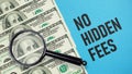 No Hidden Fees is shown using the text and photo of dollars and magnifying glass Royalty Free Stock Photo