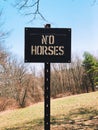 NO HORSES sign