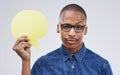 No Im not sarcastic at all. Portrait of a handsome young man holding a speech bubble against a grey. Royalty Free Stock Photo