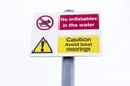 No inflatables in the water and avoid mooring sign post Royalty Free Stock Photo
