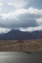 No left turn and one way sign on dessert highway. mountains in background. Royalty Free Stock Photo