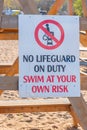 No lifeguard on duty warning sign on beach Royalty Free Stock Photo