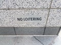 No loitering sign on black and white granite or marble wall Royalty Free Stock Photo