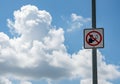 No loitering sign on pole against dramatic sky with large clouds symbolizing restriction and clear weather Royalty Free Stock Photo