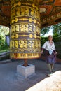 A Bhutanese gentleman rotating prayer wheel , Bhutan Royalty Free Stock Photo