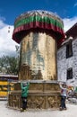 Two Tibetan boy rotating building sized prayer wheel , Tibet Royalty Free Stock Photo