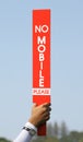 The no mobile sign was held up by volunteer in golf tournament. Royalty Free Stock Photo