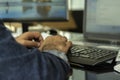 A man typing bluetooth keyboard