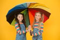 No more rain. Good mood at any weather. small girl under colorful umbrella. two happy kids yellow wall. children enjoy Royalty Free Stock Photo