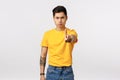 No more, stop it. Serious-looking determined young handsome asian guy with tattoos, extand arm and shaking index finger